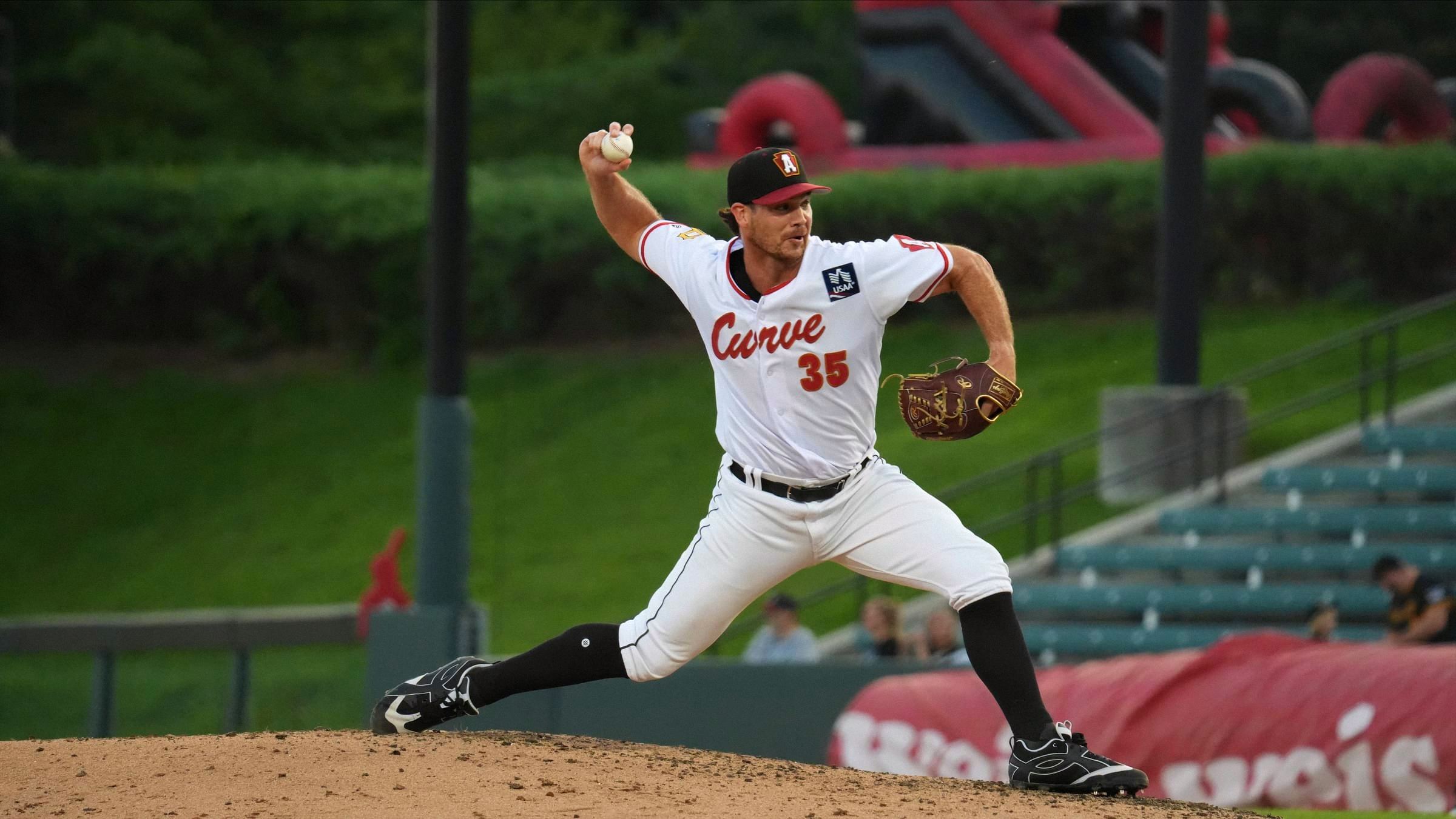 Jarod Bayless on the mound, arm back, about to throw