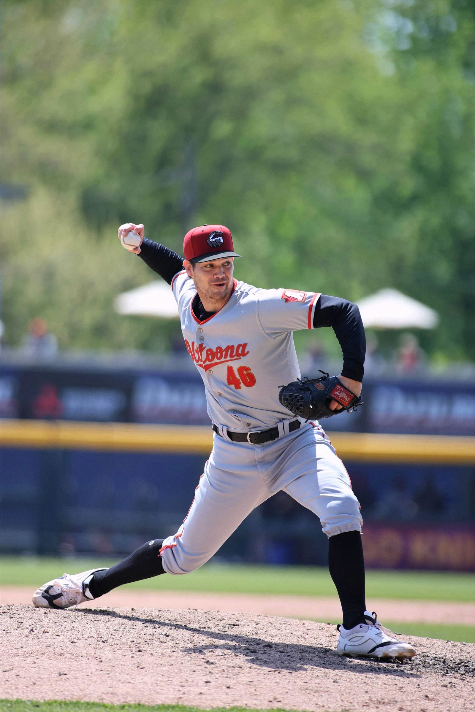 Jarod Bayless striding toward the plate, arm back